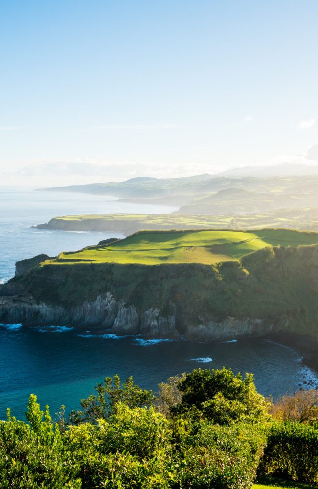 An amazing view of a green cliff near the sea in the Azores archipelago, Portugal