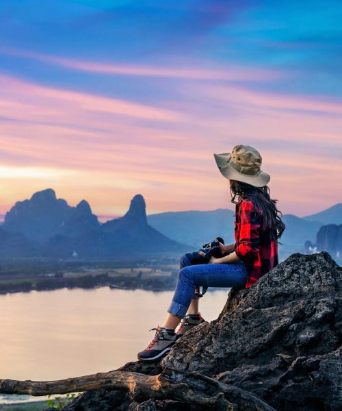 Tourist sitting on Phu sub lek viewpoint at sunset, Lopburi, Thailand.