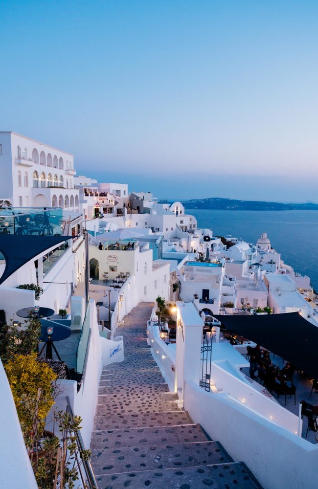 A vertical high angle shot of the white buildings in Santorini, Greece