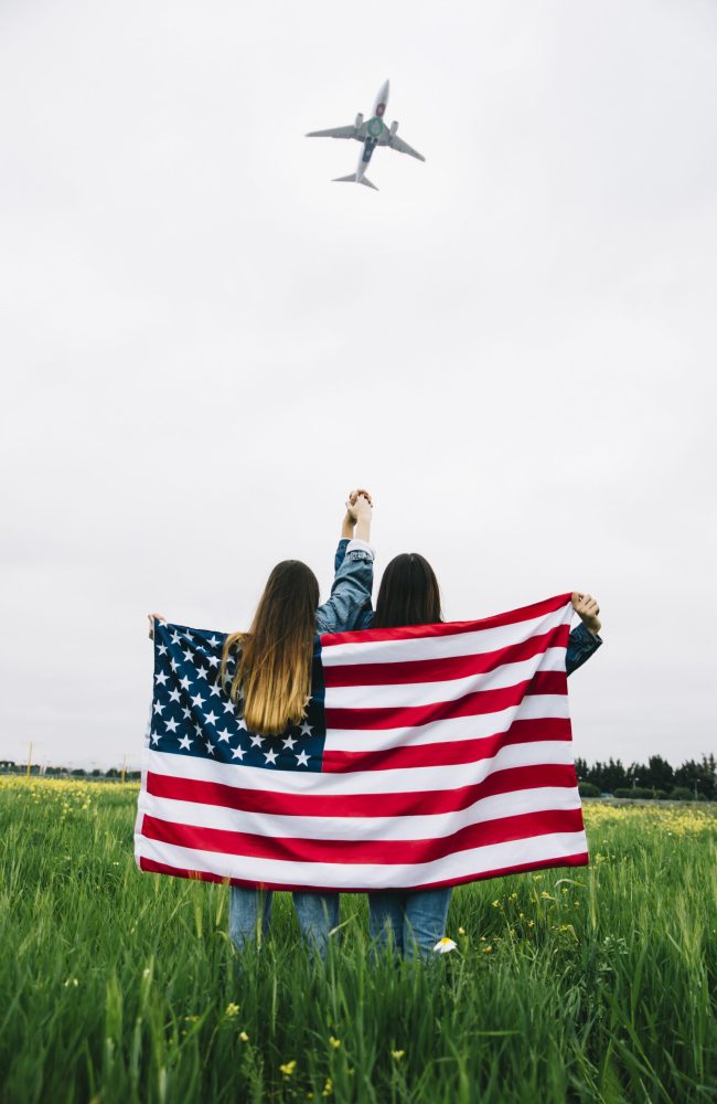 women-with-american-flag-staying-field